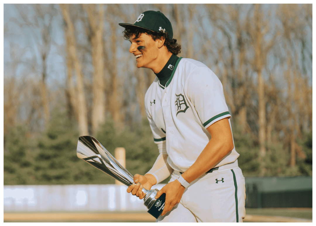 A man holding a trophy. Description generated by AI