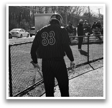 A man wearing a black and white striped jersey. Description generated by AI