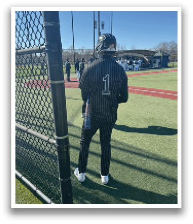 A baseball player wearing a black and white uniform. Description generated by AI