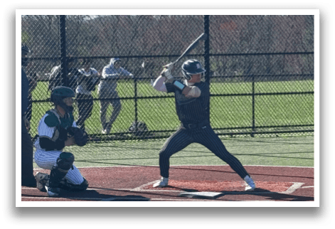 A baseball player is at bat, holding a bat and preparing to swing. Description generated by AI