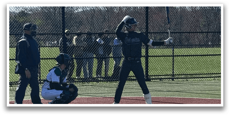 A baseball player is holding a bat and getting ready to hit the ball. Description generated by AI