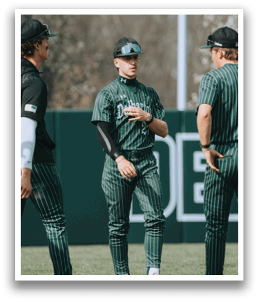 Three men wearing green and white uniforms. Description generated by AI