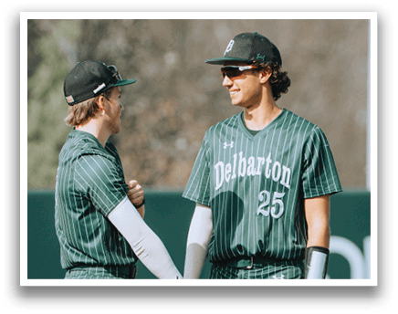 Two baseball players wearing green and white uniforms. Description generated by AI