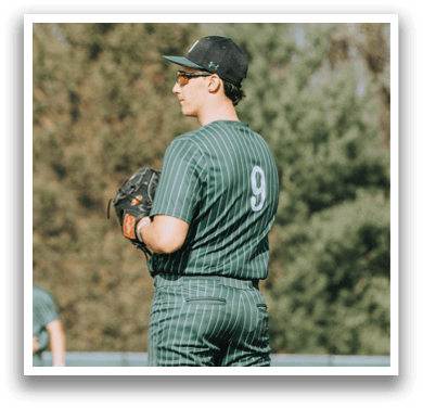 A baseball player wearing a green and white uniform with the number 9 on the back. Description generated by AI
