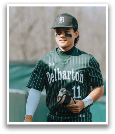 A baseball player wearing a green and white uniform. Description generated by AI