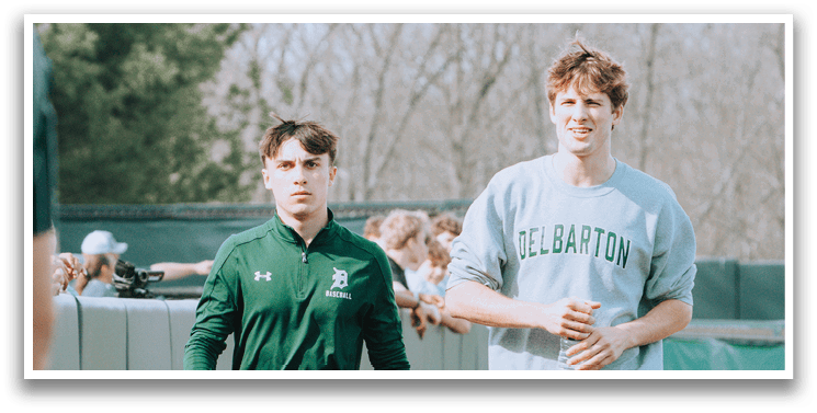 Two men walking on a path. Description generated by AI