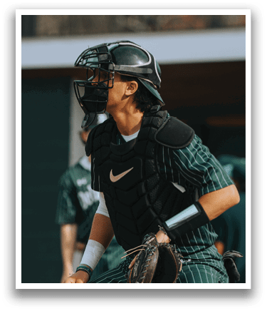A baseball player wearing a helmet and catcher's gear. Description generated by AI