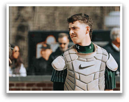 A baseball player wearing a catcher's mitt and chest protector. Description generated by AI
