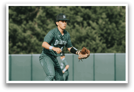 A baseball player wearing a green and white uniform. Description generated by AI