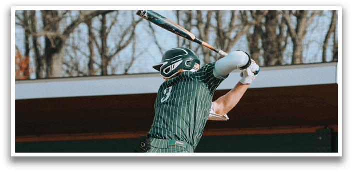 A baseball player in a green and white uniform is swinging a bat. Description generated by AI