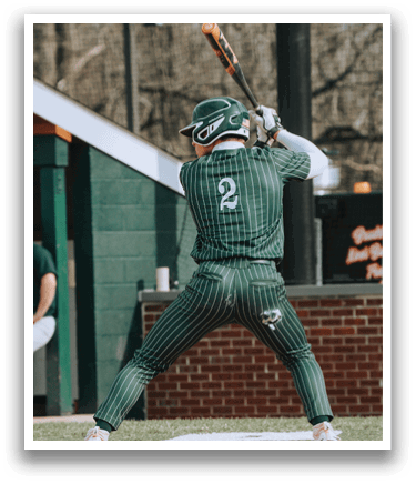 A baseball player in a green and white uniform is swinging a bat. Description generated by AI