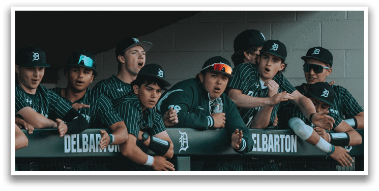 Baseball players wearing green and black uniforms. Description generated by AI