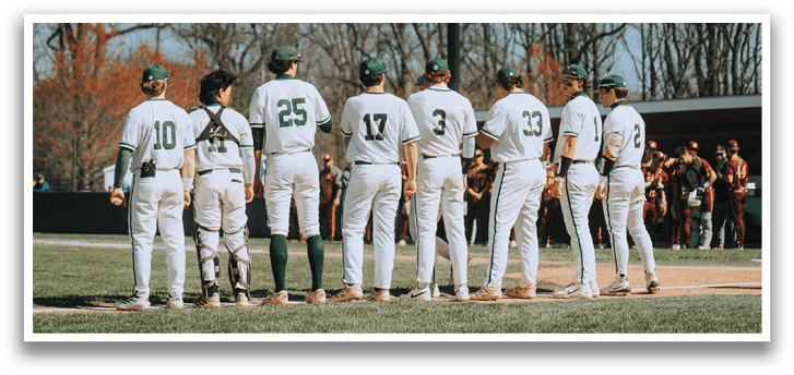A group of baseball players standing on a field. Description generated by AI