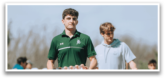 Two men walking on a path. Description generated by AI