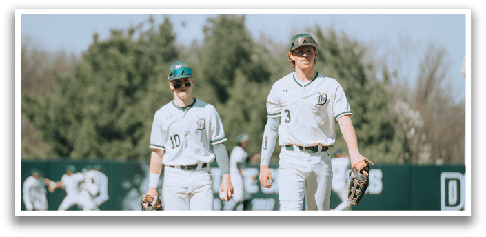 Two baseball players walking on the field. Description generated by AI