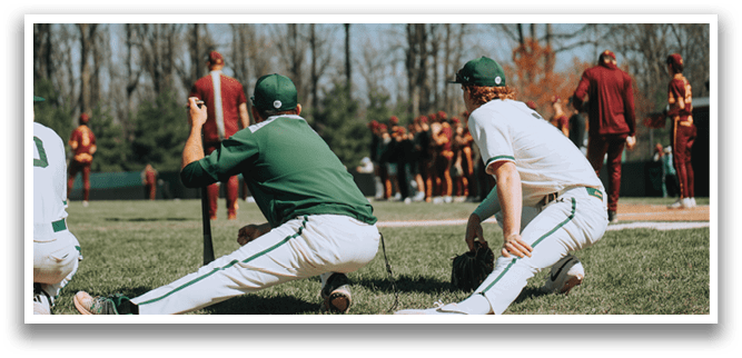Three baseball players sitting on the grass. Description generated by AI
