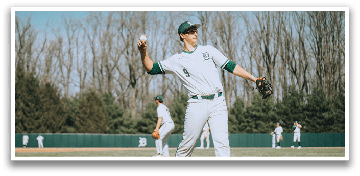 A baseball player in a white uniform is throwing a ball. Description generated by AI
