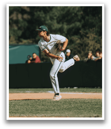 A baseball player in a white uniform is pitching a ball. Description generated by AI