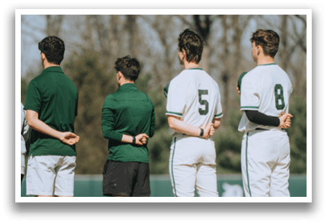 A group of people standing on a field. Description generated by AI