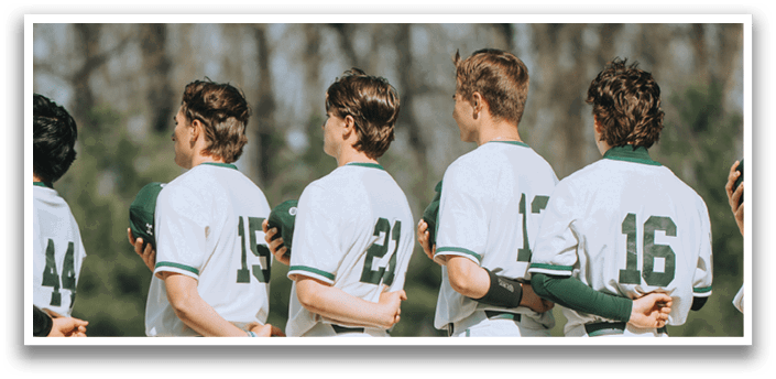 A group of baseball players standing on a field. Description generated by AI