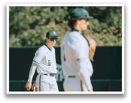 A baseball player wearing a white uniform with the number 6 on the back. Description generated by AI