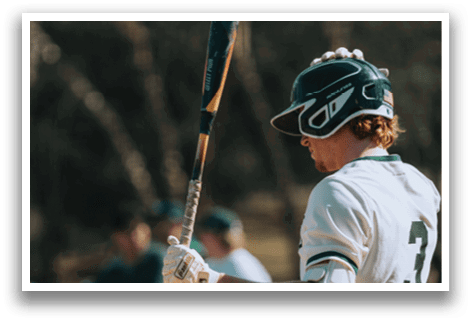 A baseball player holding a bat. Description generated by AI