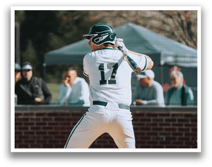A baseball player in a white uniform is swinging a bat. Description generated by AI