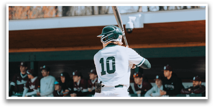 A baseball player in a white uniform with the number 10 on the back of it is holding a bat and getting ready to swing. Description generated by AI