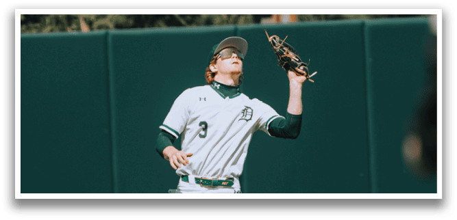 A baseball player wearing a white uniform with the number 3 on it. Description generated by AI