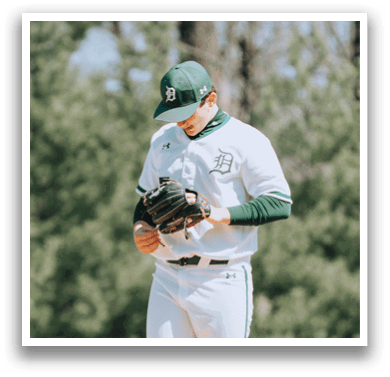 A baseball player wearing a green and white uniform. Description generated by AI