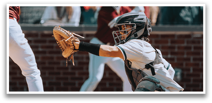 A baseball player is kneeling down with a baseball glove on. Description generated by AI