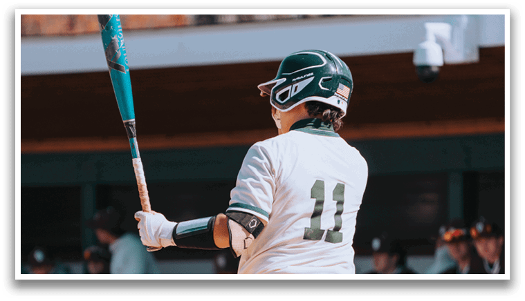 A baseball player in a white uniform holding a bat. Description generated by AI