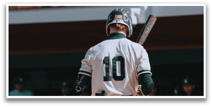 A baseball player standing on the field with a bat. Description generated by AI