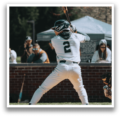 A baseball player in a white uniform is swinging a bat. Description generated by AI