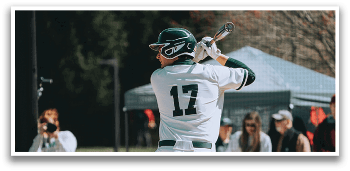 A baseball player in a white uniform is swinging a bat. Description generated by AI