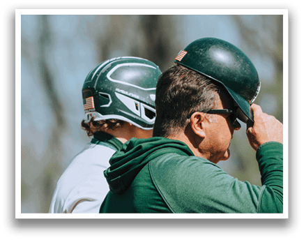 A man wearing a green shirt and a green hat. Description generated by AI
