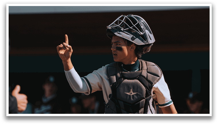 A baseball player wearing a helmet and catcher's gear. Description generated by AI