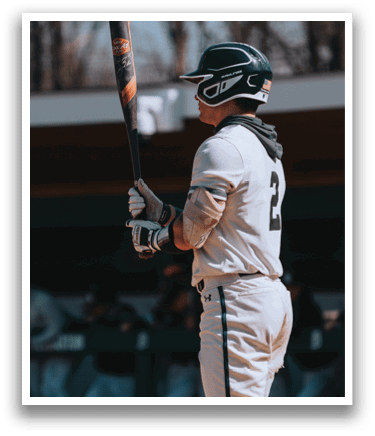 A baseball player holding a bat. Description generated by AI