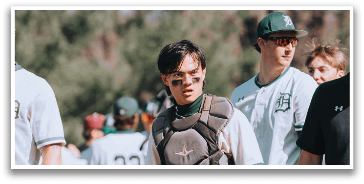 A baseball player wearing a helmet and knee pads. Description generated by AI