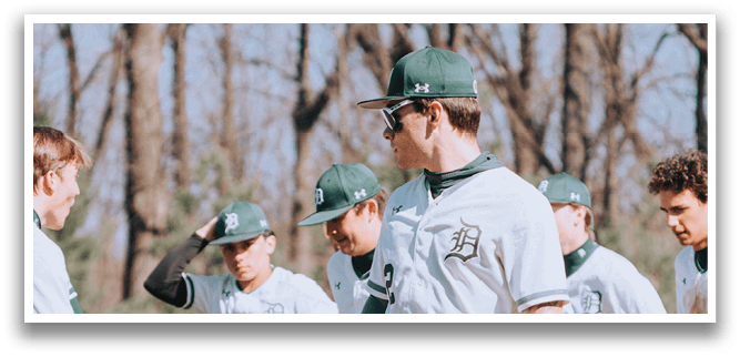 A group of baseball players walking on a field. Description generated by AI