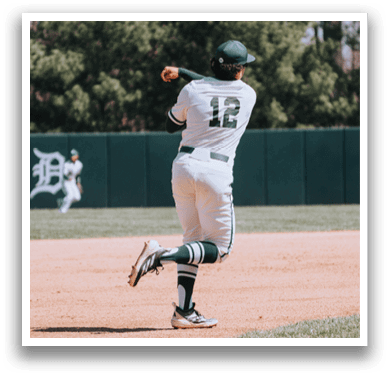 A baseball player wearing a green and white uniform is throwing a ball. Description generated by AI