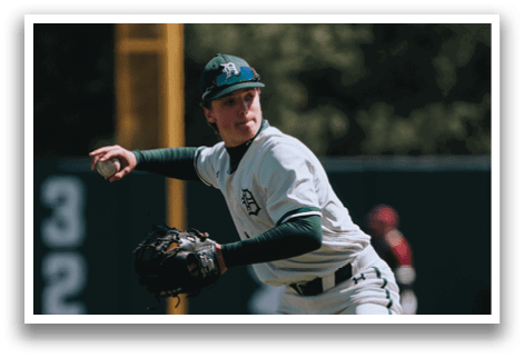 A baseball player in a white uniform is pitching a ball. Description generated by AI
