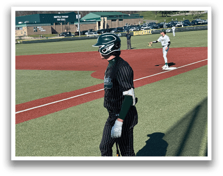 A baseball player holding a bat. Description generated by AI