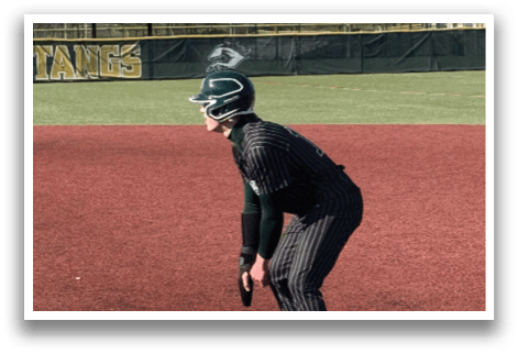 A baseball player is standing on the field. Description generated by AI