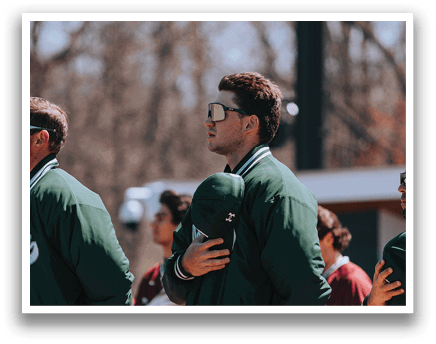 A man wearing a green jacket and a green hat. Description generated by AI