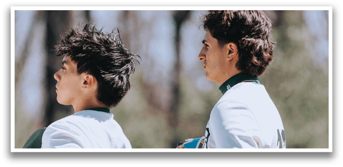 Two baseball players standing on a field. Description generated by AI