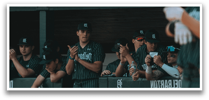 A baseball player wearing a green and white uniform. Description generated by AI