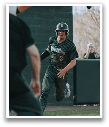 A baseball player in a green and white uniform is running towards a base. Description generated by AI