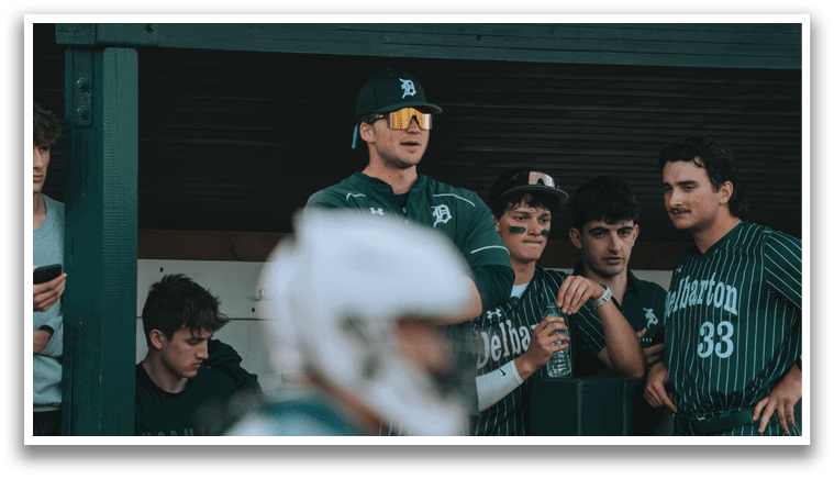 A group of baseball players sitting on a bench. Description generated by AI