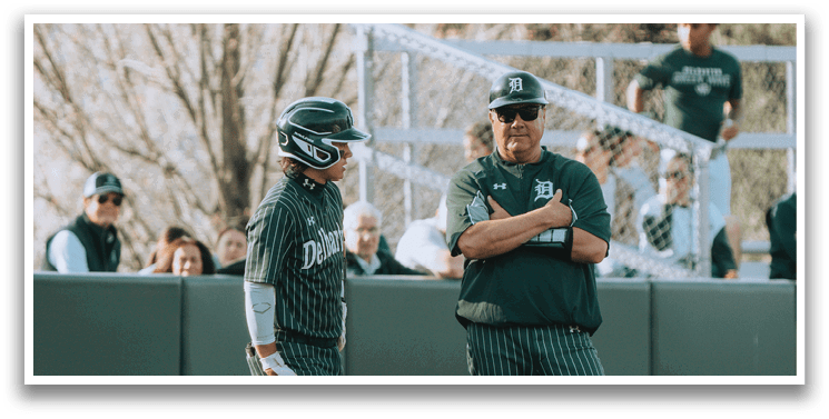 A man and woman standing on a baseball field. Description generated by AI
